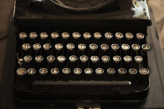 Old black typewriter with paper worth on the table