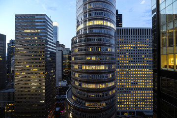 Illuminated office buildings in city at dusk