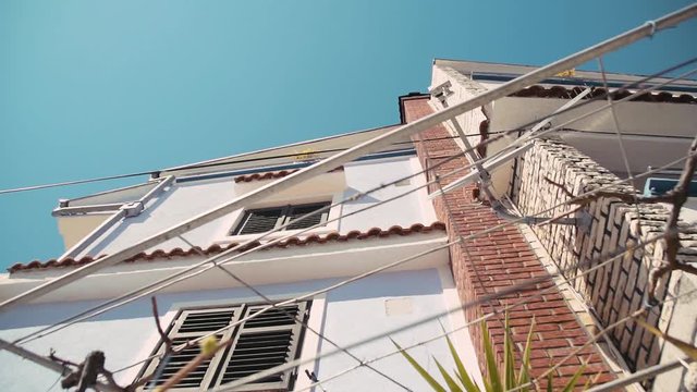 Slow motion clip of the external of an urban house in the Croatian city of Pakostane.