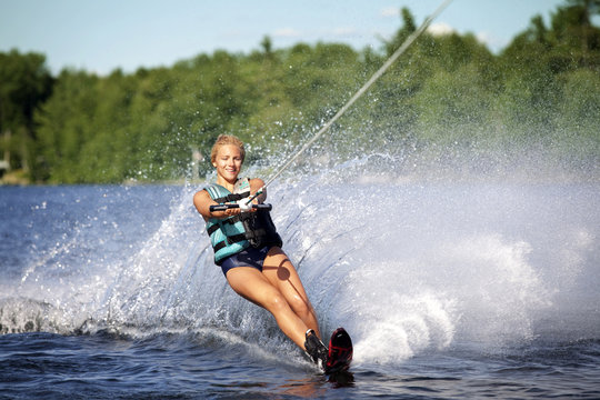 Young woman wakeboarding on river