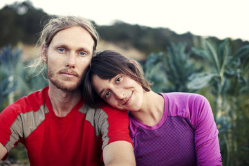 Fototapeta premium Portrait of couple sitting at farm