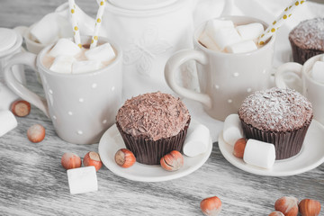 Obraz na płótnie Canvas Cacao, chocolate cupcakes, hazelnuts and different decorations
