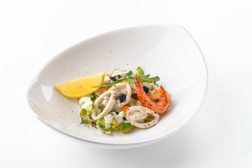 Salad from shrimps, arugula and squids. Restaurant menu. White background.