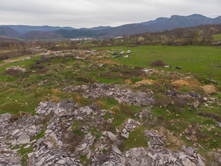 Landfill in the mountain, City Dump. People working and collecting the Garbage, Aerial view