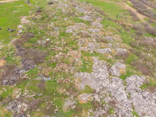 Landfill in the mountain, City Dump. People working and collecting the Garbage, Aerial view