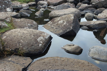 Broken Reflections Water and Rocks