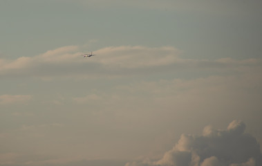 Silhouette of a plane taking off against the blue sky