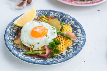 Fried egg with potato and jamon ham, spain cuisine, close view
