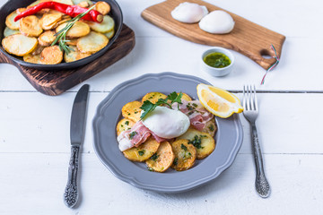 Spanish tapas huevos rotos. Fried eg, jamon ham and potato