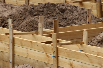 Wooden formwork concrete strip foundation for a cottage