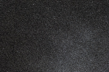 Macro backdrop of dark grunge concrete wall texture .