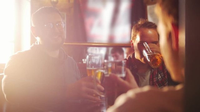 Good old friends drinking beer in a pub