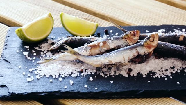 tasty dish of baked sprat baked in the oven on a pillow of sea salt