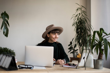Portrait of stylish freelancer working project in modern office using laptop computer.Successful...