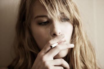 Close-up of woman looking away while smoking © Cavan for Adobe