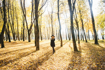 Beautiful happy smiling girl with long blonde hair, red lips, wearing stylish hat,  jacket posing in autumn street. Outdoor portrait, day light. Female autumn fashion concept.