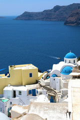 Santorini: Oia traditional greek white village with blue domes of churches, Greece.