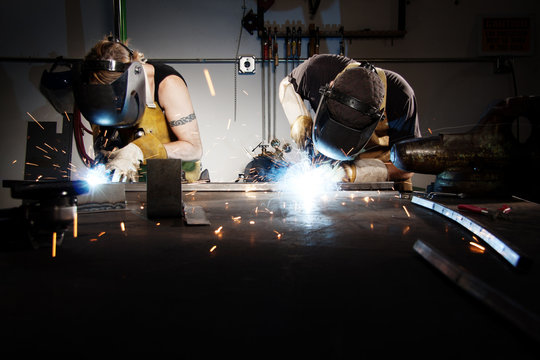 Workers welding in factory