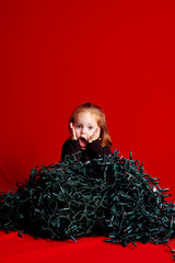 Shocked Girl Sitting in Tangled Christmas Lights