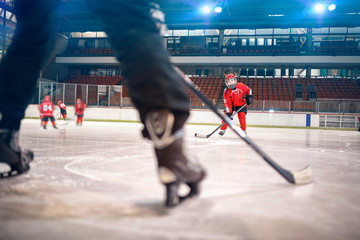 Hockey match at rink boy player in action .