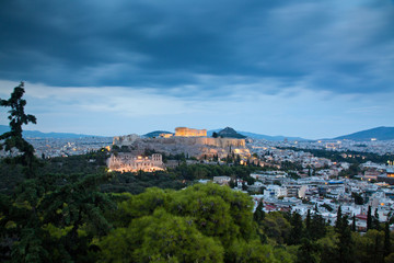 Fototapeta na wymiar athens seen from Philopapou hill with views to Herodium , Acropolis and the Parthenon at blue hour, Attica, Greece