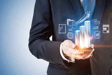 Businessman with phone, bar chart net interface