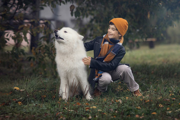 boy with samoyed dog