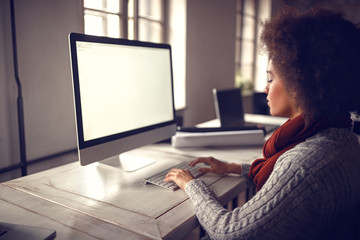 Afro-American woman at job in project office