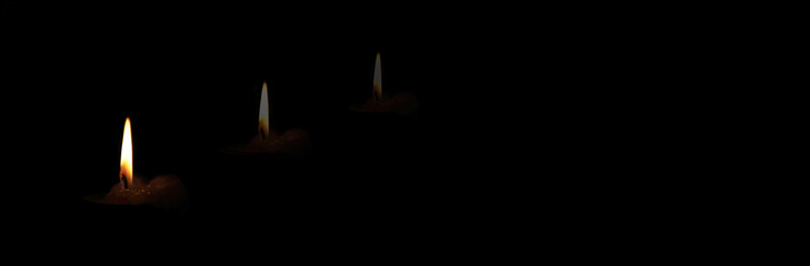 The concept of mourning. Candle on a dark background and reflection. We remember, we grieve....