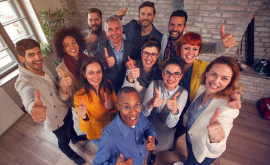 Group of success business team giving thumbs up.
