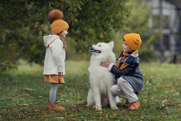 boy and girl looking at dog