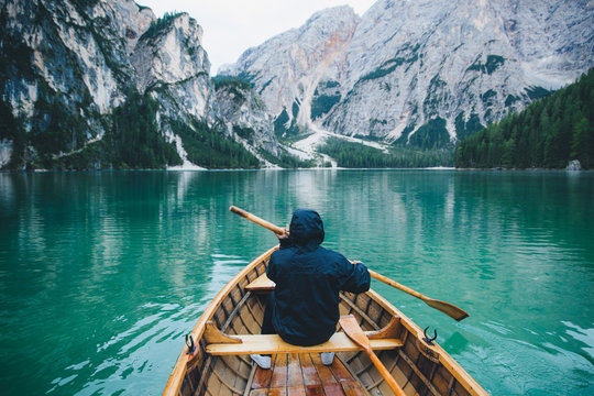 Man Aboard Wooden Boat in Italian Alpine Lake