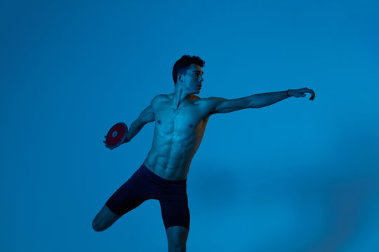 Sportsman throwing discus in blue