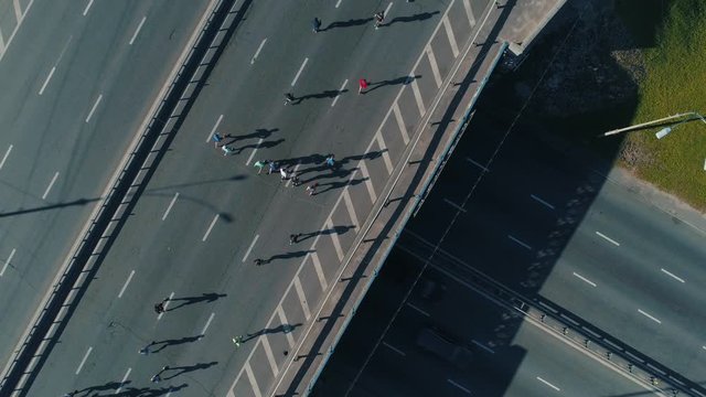Aerial Drone Fooage. Marathon Running On road bridge. Top View