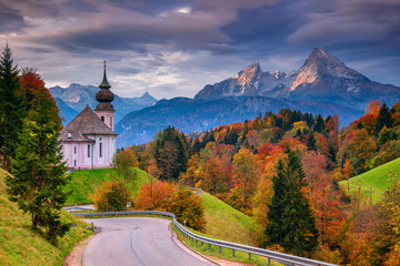 Autumn in Alps. Image of the Bavarian Alps with Maria Gern Church and Watzmann mountain during beautiful autumn sunrise.