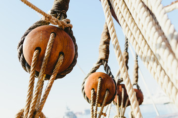 Rigging and ropes on an old sailing ship to sail in summer. - obrazy, fototapety, plakaty