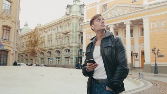Young brutal man travels in an unfamiliar European city. Slo-mo