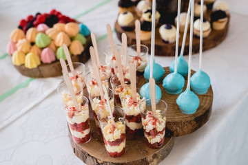 Desserts and wedding cake with very sweet cupcakes at an event.