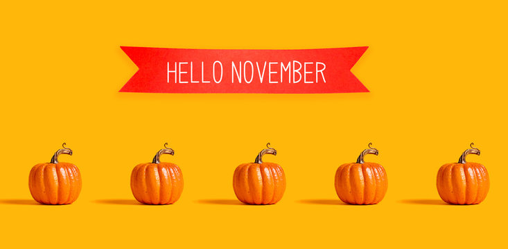 Hello November with orange pumpkins with a red banner