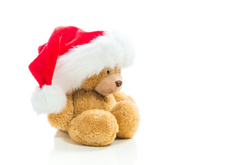 Teddy bear with a Santa hat isolated on white background