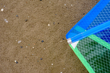 Detail of a windsurfing sail on the sand.
