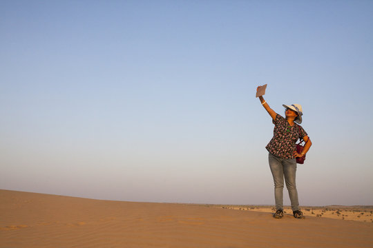 A woman taking selfie in Thar Desrt