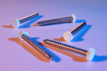 Held together by pills, illustrated by using pills as screwheads. Screws are used to hold things together.