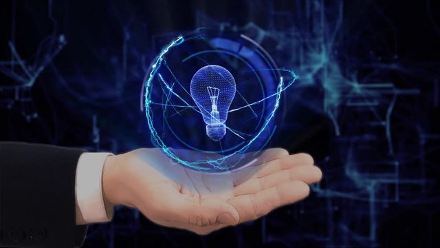 Painted hand shows concept hologram Bulb Lamp on his hand. Drawn man in business suit with future technology screen and modern cosmic background