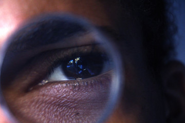 eye through magnifying glass