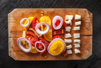 Vegetables and pig fat on vintage chopping board