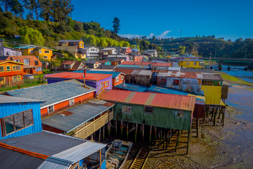 Fototapeta na wymiar Above beautiful and colorful houses on stilts palafitos in Castro, Chiloe Island