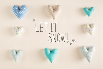 Let It Snow message with blue heart cushions on a white paper background