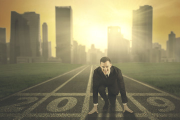 Caucasian businessman kneeling on numbers 2019