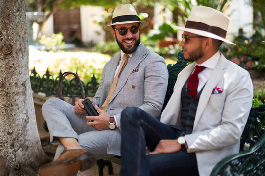 Two happy stylish men in a park